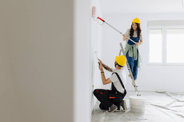 istock Young workers with painting tools indoors. Room renovation 2185550665