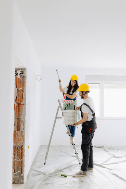 istock Young workers with painting tools indoors. Room renovation 2185550759