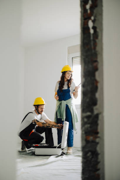 istock Young workers with painting tools indoors. Room renovation 2185550817