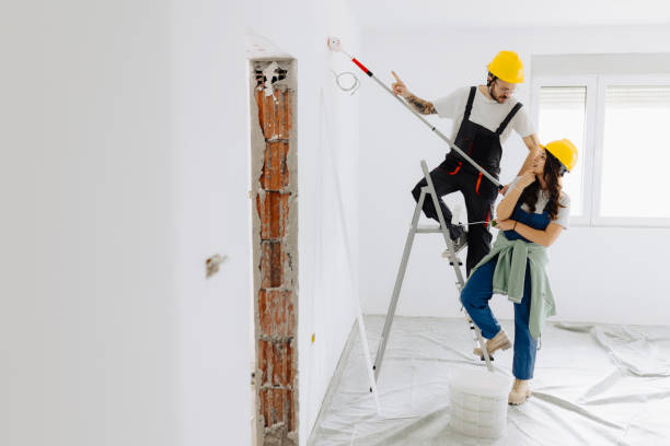 istock Young workers with painting tools indoors. Room renovation 2185550977