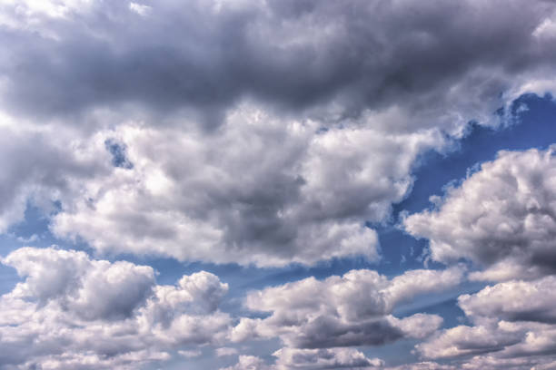 A picturesque sky background featuring fluffy cumulus clouds on a sunny day. The scene is perfect for a variety of uses, from backgrounds to nature concepts and more.
