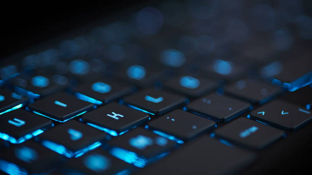 istock blue glowing modern keyboard with blurred bokeh background 2185554852