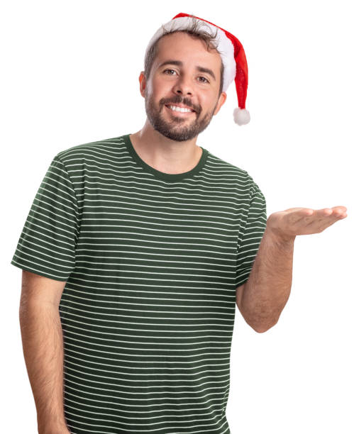 Smiling bearded guy wearing Santa hat with hand to side holding something with blank space