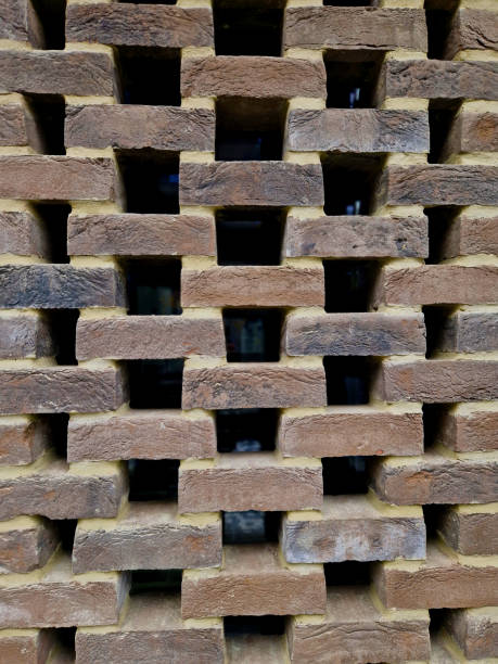 istock fence around the garden built of burnt clay bricks with large gaps. creates a light structure of otherwise massive cubes of the structure connected by cement mortar. masonry industry 2185556518