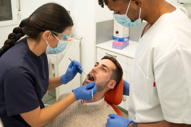 istock Dental team working together during a patient's dental examination 2185556923