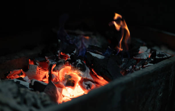 istock Glowing Embers and Flickering Flames in Charcoal Stove 2185558070