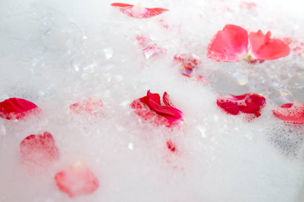 istock White bath foam with red roses petals floating, abstract bubbles texture backdrop 2185565448