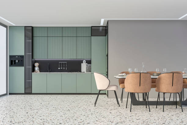 istock Modern light blue kitchen with a full dining table, and beige and camel brown leather chairs in front of an empty light pastel green wall with copy space, on terrazzo floor, a large window on a side 2185565472