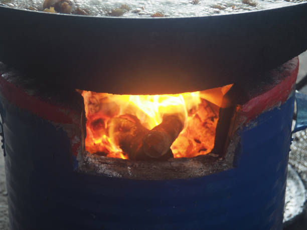 istock clay firepot and brazire burnning wood with cooking pan 2185566342