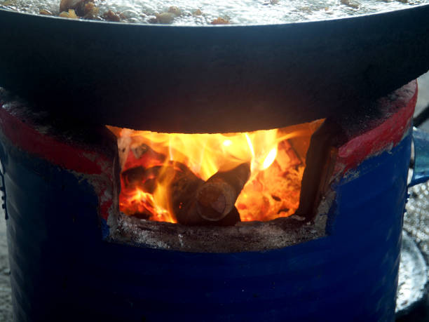 istock clay firepot and brazire burnning wood with cooking pan 2185566343