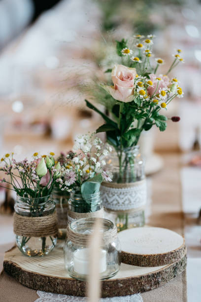 istock Rustic Wedding Table Setting with Vintage Glass Bottles, Wood Slices and napkins 2185567130