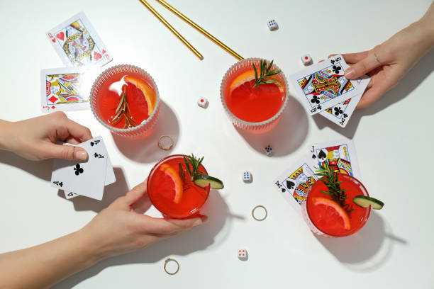 istock Grapefruit cocktails, cards in hands and rings on white background, top view 2185568309