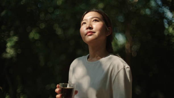 Woman drinking coffee at nature.
