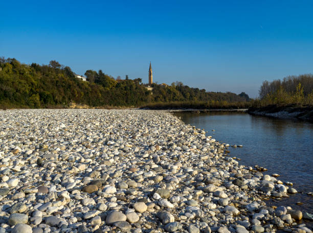 Landscape of the dry Piave riverbed, with a stony bottom, in Italy