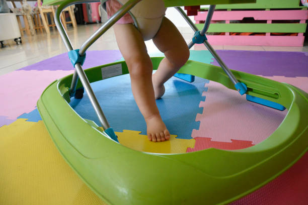 istock Cute baby making first steps with toy walker at home. 2185571464