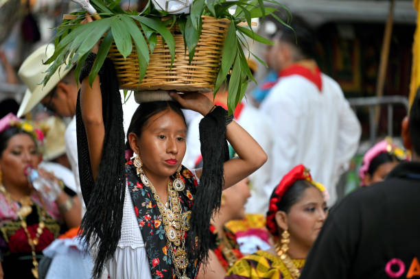 Oaxaca, Mexico - July 10, 2023: Unidentified people dance during a traditional folklore festival on the street in Oaxaca, Mexico.