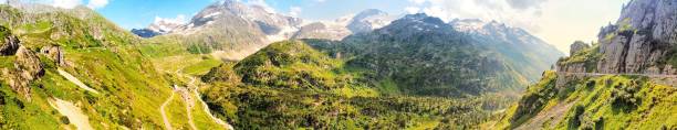 istock panoramic view of a winding river cutting through lush green fields at sunset with a vibrant sky 2185572244