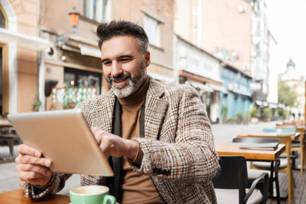 istock Businessman on Tablet in Urban Setting 2185573370