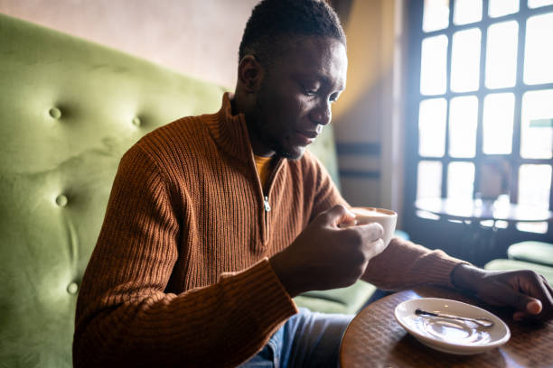 istock Young man enjoys his moment with coffee in the cafeteria 2185573641