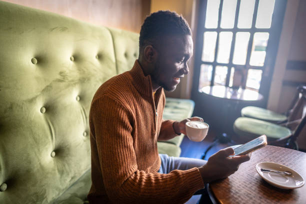 istock Man drinking a cup of coffee at a cafe 2185573676