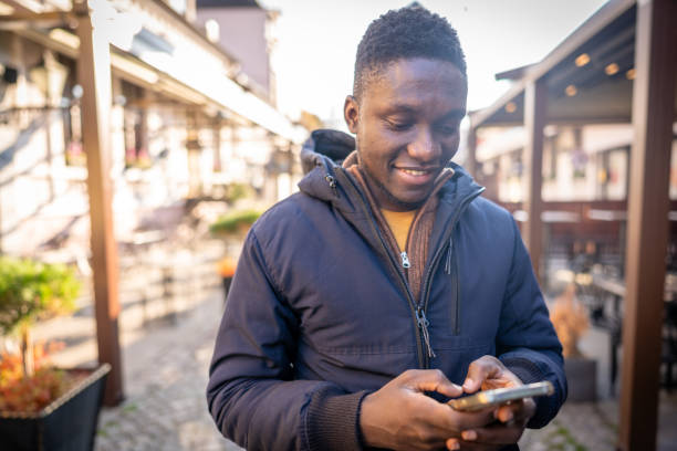 istock Young african american using a smart phone 2185573817
