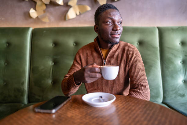 istock Young man enjoys his moment with coffee in the cafeteria 2185574447