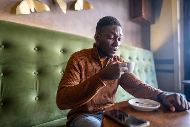 istock Young man enjoys his moment with coffee in the cafeteria 2185574570