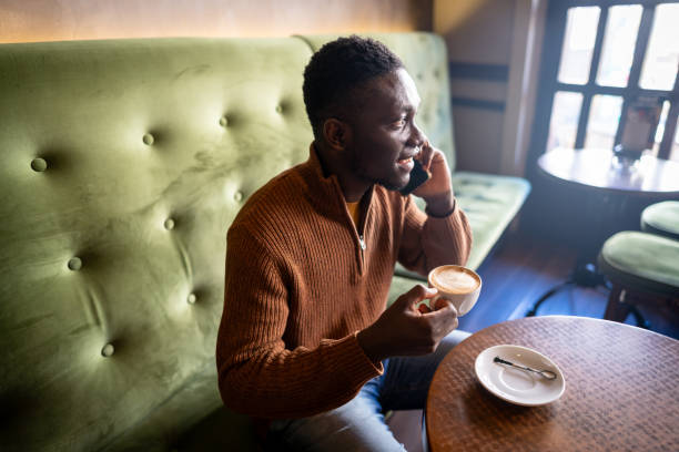 Man drinking a cup of coffee at a cafe