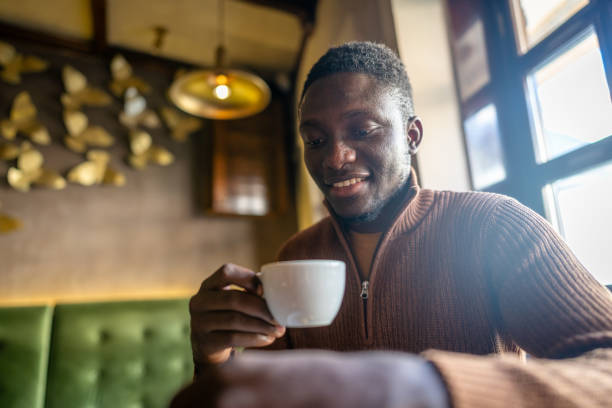 istock Afro-american man drinking coffee in cafe 2185574888