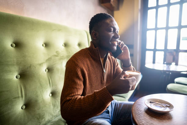 istock Man drinking a cup of coffee at a cafe 2185574912