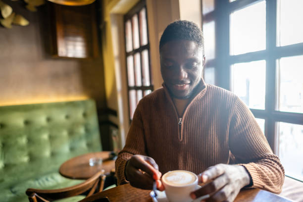 istock Afro-american man drinking coffee in cafe 2185575142