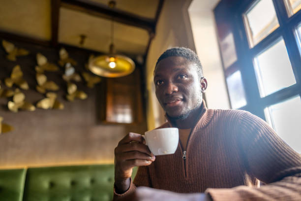 istock Afro-american man drinking coffee in cafe 2185575181