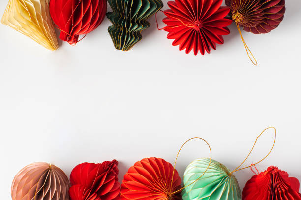 istock Bright paper Christmas tree decorations on white. Stylish Christmas decorations. Copy space 2185575889