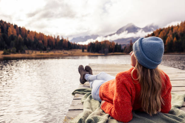 Woman Relaxing on a Dock Overlooking a Mountain Lake