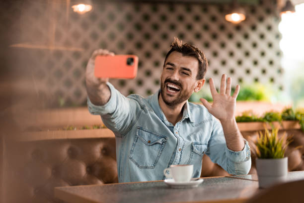 istock Young man taking a selfie in coffee shop. 2185576318