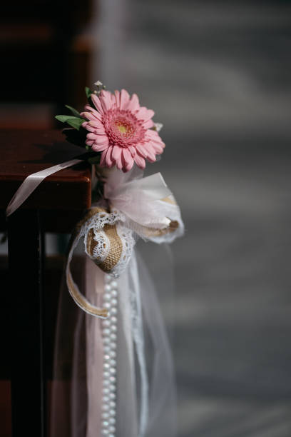 istock Pink Gerbera Daisy Wedding Pew Decoration With Pearls And Lace 2185577936