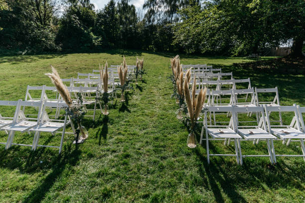 istock White Wedding Ceremony Setup with Pampas Grass Aisle Decoration in Garden 2185578550