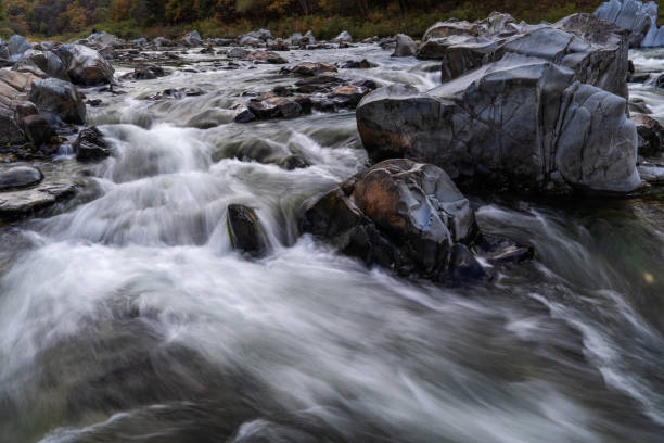 istock flowing water at the stream in the autumn valley 2185580646