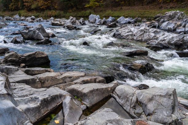 istock rocks and flowing stream in the autumn valley 2185581286