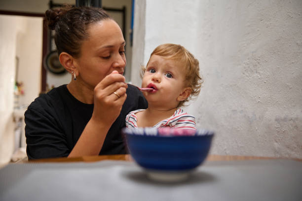 istock Mother feeding her toddler in a cozy home setting 2185582225