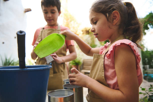 istock Children engaged in outdoor gardening with soil and tools 2185583323