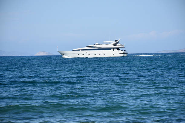 Aegina, Greece - September 29, 2024: Aegina Port In Greece, Balkan Peninsula, Southeast Europe, Docked Boat, Mountain, People