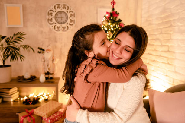 istock Mom hugs her daughter for Christmas 2185583904