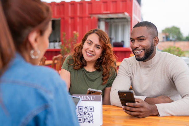 istock Happy friends smiling while talking at a fast food restaurant 2185584044