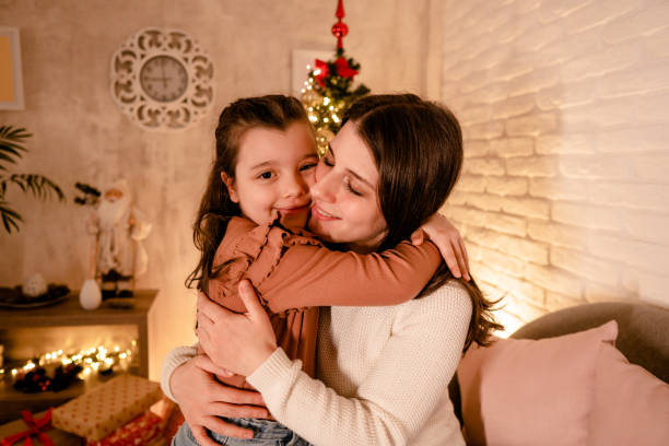 istock Mom hugs her daughter for Christmas 2185584077