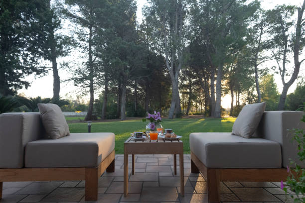 istock A serene outdoor seating area featuring a table with a lovely garden view 2185584336