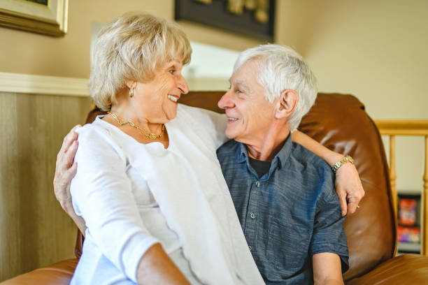 istock elderly 80s couple embracing each other at home 2185584594