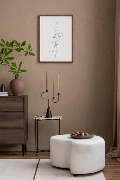 istock Cozy corner featuring a boucle ottoman, sleek candle holder, and minimalist decor. The warm tones and simple yet elegant design make this space perfect for relaxation. Mock up poster. 2185585154