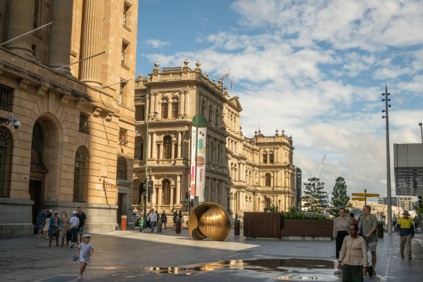 The Former Treasury Building seen to the left in the image, in downtown Brisbane, is a grand 19th-century sandstone landmark, now housing a casino and hotel.