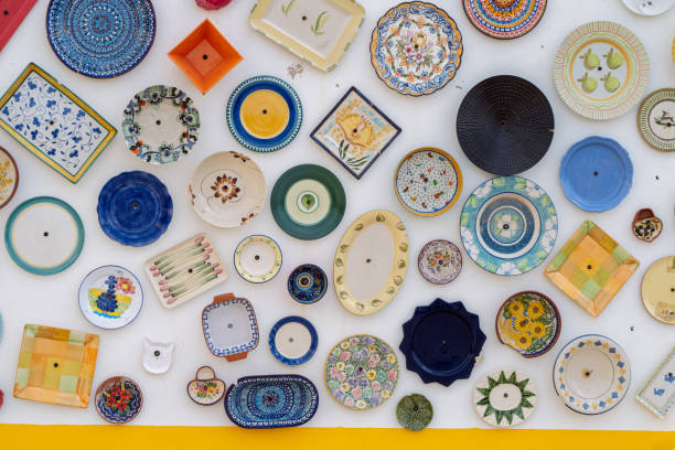 istock Colorful ceramic plates and dishes hanging on a white wall, creating a vibrant display 2185587160